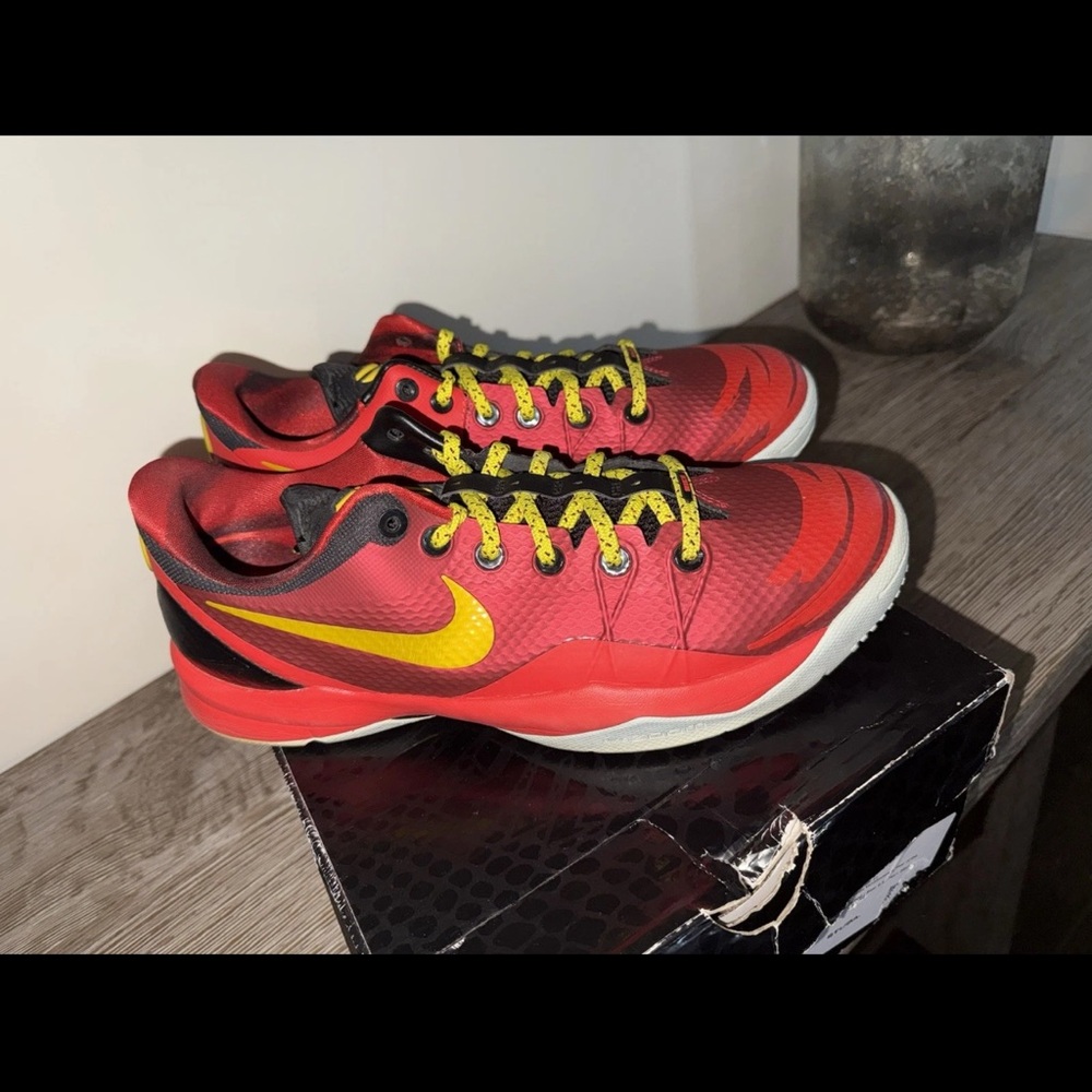 Nike Red Athletic Shoes with Yellow Swoosh